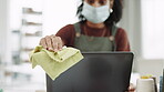 Covid, cloth and a business black woman cleaning her computer in the office at work for disinfection. Hand, hygiene or sanitizer with a female employee wiping a desktop monitor for health regulations