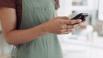 Closeup, hands and woman with smartphone, connection and communication in workspace, texting or chatting. Zoom, female employee or creative with cellphone, social media or message with network signal