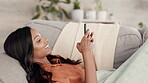 Woman, phone and chatting relaxing on living room sofa in communication, texting or social media at home. Happy female lying on couch with smile typing on smartphone for networking, browsing or chat