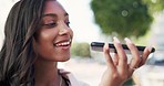 Voice note, phone audio and talking Indian woman outdoor with communication and smile. Blurred background, 5g connectivity and conversation of a young female networking on a web app with happiness