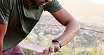 Fitness, man and watch in running start checking time for cardio exercise, workout or training on mountain. Active male runner looking at wristwatch starting intense run or exercising in nature