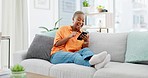 Black woman, texting and phone on sofa for meme, relax or comic video on social network ux in house. Gen z African, laughing and smartphone with reading funny blog, app ux and happiness in apartment