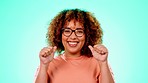 Happy, excited and portrait of a woman with finger guns isolated on blue background in studio. Smile, happiness and young girl with expression, excitement or gesturing for a cool sign on a backdrop