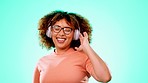 Headphones, dance and black woman in studio with smile and isolated on turquoise background with happiness. Music, streaming service and dancing, excited African person with online radio station app.