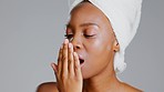 Shower, breath check and morning grooming of a black woman in a studio with beauty routine. Dental, healthcare and female model with gray background checking mouth odor for hygiene and teeth health