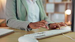 Woman, hands and typing on computer at night for research, planning or project deadline at the office desk. Hand of female business employee working late on desktop PC keyboard for online search