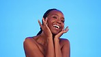 Beauty, black woman hands on face in studio for wellness, hygiene and body care on blue background. Skincare, portrait and girl model relax with luxury, glow and anti aging cosmetics while isolated 