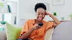 Phone, typing and black woman laughing on sofa in home living room, social media meme or web scrolling. Comic, cellphone and happy female with mobile smartphone for funny message or internet browsing