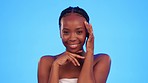 Face, black woman and cosmetics, for beauty, smile and body care against a blue studio background. Portrait, Nigerian female and lady with skincare, shine and confidence with wellness and smooth skin