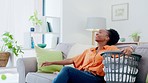 Black woman, cleaning service and laundry with clean house, housekeeper rest with housework and clothes. Female cleaner, housekeeping and hygiene, break and washing basket on couch with relief