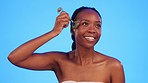 Skincare, jade roller and black woman in studio for wellness, anti aging and cosmetics on blue background. Facial, massage and tool for girl skin model with luxury, beauty and lymphatic treatment 