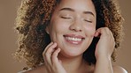 Black woman face, beauty closeup and cosmetic wellness of a model in studio with happiness. Skin glow, cosmetics and young African person with a smile from dermatology skincare with brown background