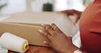 Black woman, hands and box in logistics for delivery, ecommerce or shipping cargo at office desk. Hand of African American female in small business packing product for shipment or courier service