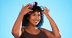 Afro, smile and black woman with roller for hair on blue background for curly, natural and hairstyle. Beauty salon, hairdresser and happy girl with accessory for wellness, grooming and cosmetics