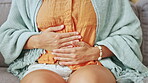 Sick woman, pain and hands on stomach in house for ibs, indigestion and pms nausea of medical virus. Closeup female, menstruation and abdomen problem of constipation, gastric health and endometriosis