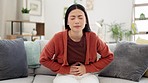 Ibs, constipation and sick woman with stomach pain, menstruation cramps or food poisoning. Indigestion, painful and Asian lady with diarrhea, bloating and suffering with period cramping on the sofa