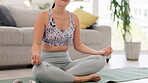 Meditation, lotus and woman in living room for stress management, balance and peace with spiritual healing. Calm, zen and young person meditate, yoga or breathing on floor in lounge for body and mind