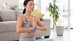 Namaste hands, yoga and woman praying in living room calm, peace and mindfulness for fitness and holistic meditation. Meditate, prayer hands and spiritual asian person for wellness training in lounge