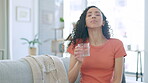 Health, woman on couch and pill with water, wellness and treatment in living room, care and relief. Female, lady or liquid with medication, anxiety or illness with aqua, medicine or cure for sickness