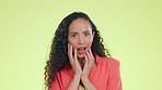 Woman, shocked and surprised face of a mixed race female hearing gossip and announcement. Isolated, studio and green background with a young person portrait feeling surprise from omg and wow news