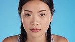 Tired, fitness and breathing with asian woman in studio for workout, intense cardio or performance. Training, sweating and exercise with girl athlete on blue background for focus, strong or challenge