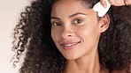 Face, gua sha and black woman in studio for skincare, circulation and facelift on brown background. Portrait, facial massage and beauty product for wellness model relax with luxury, stone and tool 