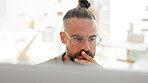 Contemplating, thinking and businessman working computer planning startup growth strategy in an office with focus. Serious, vision and inspiration by entrepreneur searching the internet or web