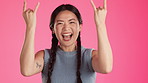 Rock, music and metal with asian woman in studio and for trendy, punk and crazy isolated on pink background. Edgy, track and happiness with girl and hand sign for positive, funky and carefree 