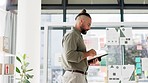 Happy man working on tablet in startup office, creative design studio or workplace success, goals and management. Creative worker or person typing on digital technology and walking in business office