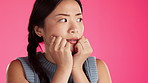 Worried, fear and scared Asian woman with hands on face feeling anxious isolated in a studio pink background. Anxiety, paranoid and female with depression or schizophrenia thinking of crisis 