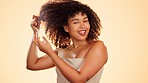 Face, hair care and beauty of woman with comb in studio isolated on a brown background. Cosmetics, salon treatment and portrait of happy female model with product or tool for combing curly hairstyle.