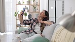 Selfie, happy and woman with a peace sign on the sofa for social media, profile picture or fun. Carefree, relax and girl taking a photo on the couch for a memory, happiness and playful at home