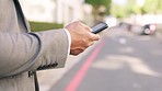 Phone, hands and businessman in city street, texting and search while outdoors for travel on blurred background. Smartphone, zoom and guy check online app for location, maps or directions on commute