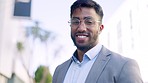 City, smile and Indian businessman with glasses, confidence and vision outside with success and pride. Face of happy, confident and successful portrait of corporate ceo man standing on street smiling