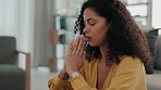 Religion, faith and woman saying a prayer in her living room for worship, spiritual wellness and forgiveness. God, believe and christian female praying for compassion, hope and peace in her home.