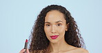 Face, beauty and red lipstick, makeup and black woman with cosmetic product on blue background. Female in portrait, confident with cosmetics for lips and cosmetology with skincare glow in studio