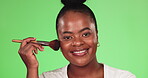 Black woman, face and makeup brush portrait for beauty and cosmetics for a glow and shine in studio. Happy aesthetic female model on a green background for facial self care and skincare with a smile
