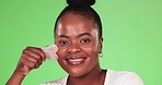 Face, skincare and black woman with cotton pad, makeup and smile against a studio background. Portrait, African American female and lady with cosmetics tool, green screen and treatment for soft skin