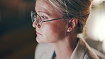 Senior woman, face closeup and serious business employee working on a computer, Night typing, digital planning and focus of a female doing design content management work in a office in the dark