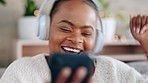 Headphones, smartphone and black woman dancing, sofa and happiness with sounds, listen to music and relax. Dance, Nigerian female and lady with headset, mobile phone and audio streaming with smile