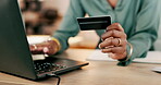 Laptop, credit card and woman hands for business online shopping, transaction or fintech payment in night office. Professional black person typing her banking information on computer or financial app