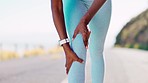 Injury, massage and woman with knee pain while running, fitness emergency and accident. Injured, joint and athlete feeling a leg for a sprain, strain and rupture in the street during cardio exercise