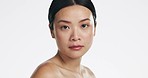 Beauty, skincare and face of an Asian woman in a studio with a natural, cosmetic and health routine. Wellness, self care and portrait of a female model with clear and glowing skin by white background