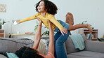 Love, mother and girl on sofa, airplane and quality time in living room, happiness and relax together. Family, mama and daughter flying, couch and playing in lounge,  fun and loving with joy and care