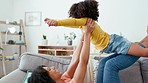 Airplane, mother and daughter playing on a sofa, bonding and having fun in their home together. Love, flying and game by girl with mom on a couch, relax and happy in a living room on the weekend