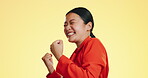 Face, winner and celebration of excited Asian woman in studio isolated on a background. Success, portrait smile and happy female after winning lottery, prize and competition, good news and bonus.