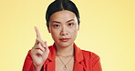 Face, warning and Asian woman serious, finger and stop against a studio background. Portrait, Japanese female and lady with hand gesture for rejection, unhappy girl and frustrated with disagreement