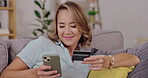 Woman, phone and credit card of sofa for ecommerce, online shopping or internet banking at home. Happy female shopper on smartphone relaxing on living room couch for wireless transaction or purchase