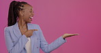 Portrait, promotion and a business black woman pointing to blank mockup space for product placement. Advertising, branding and marketing with a female employee in studio on a mock up pink background