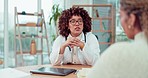 Woman doctor speaking to patient in office for infertility treatment, healthcare advice or consulting services. Biracial medical professional giving serious news, feedback and talking in consultation